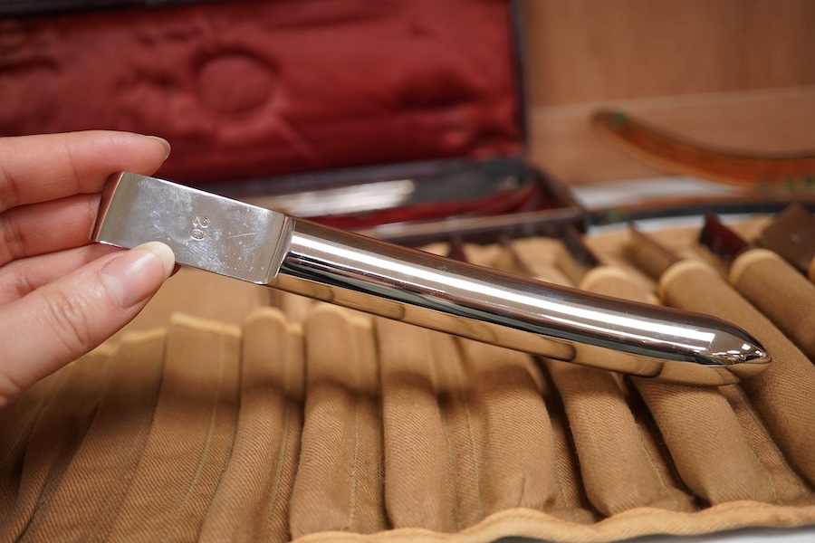 A late 19th century leather cased medical set of catheter surgical instruments, together with a single leather case catheter, plus an early 20th century canvas roll containing a graduated set of gynaecological surgical i